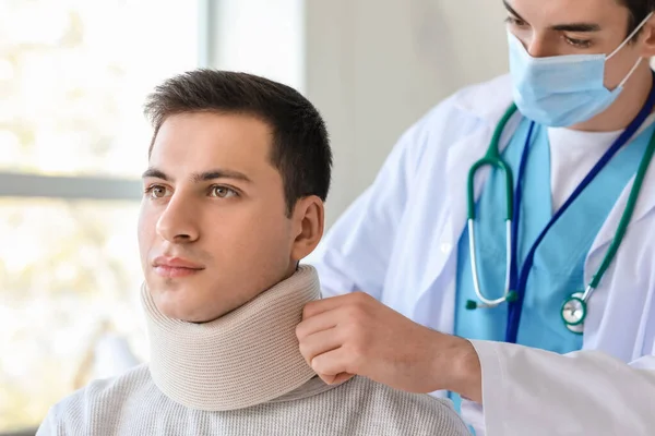 Doctor Applying Cervical Collar Neck Young Man Clinic — Stock Photo, Image