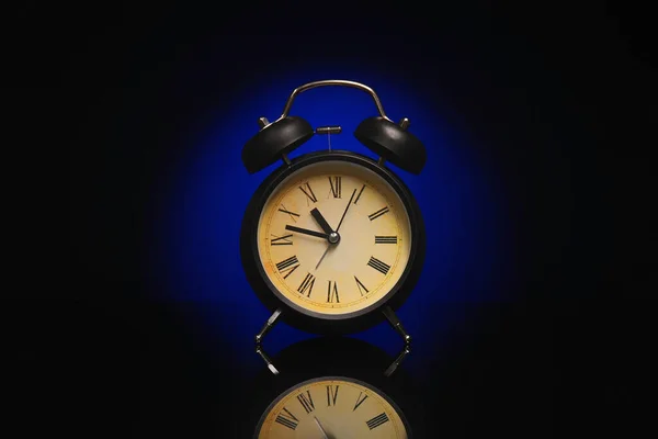 Alarm clock on black background