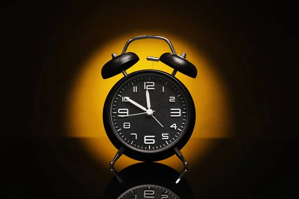 Alarm clock on black background