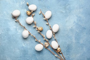 Composition with Easter eggs and pussy willow on color background