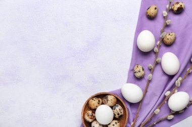 Composition with Easter eggs and pussy willow on light background