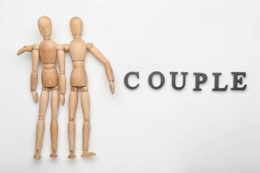 Beyaz arka planda kelime çiftli ahşap mankenler