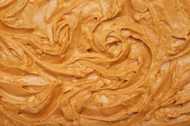 Arka plan olarak lezzetli fıstık ezmesi, yakın plan.