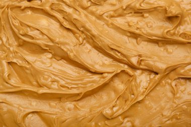 Arka plan olarak lezzetli fıstık ezmesi, yakın plan.