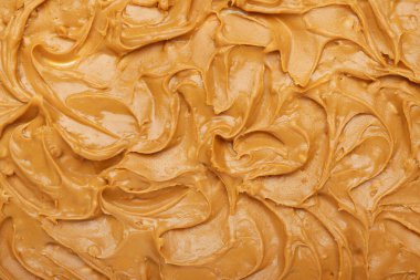 Arka plan olarak lezzetli fıstık ezmesi, yakın plan.