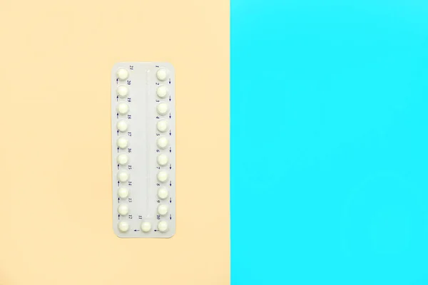 Strip of birth control pills on color background