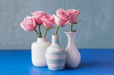 Renkli vazolarda güzel pembe güller