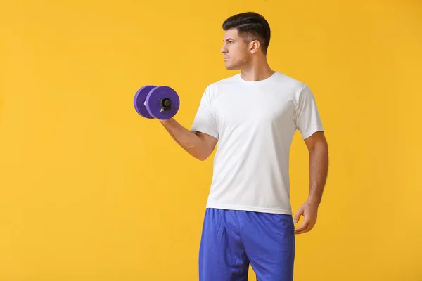 Sporty Young Man Training Dumbbell Color Background — Stock Photo, Image