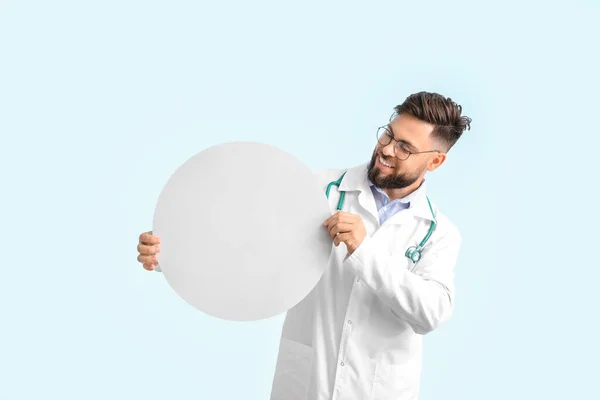 Doctor with blank poster on color background