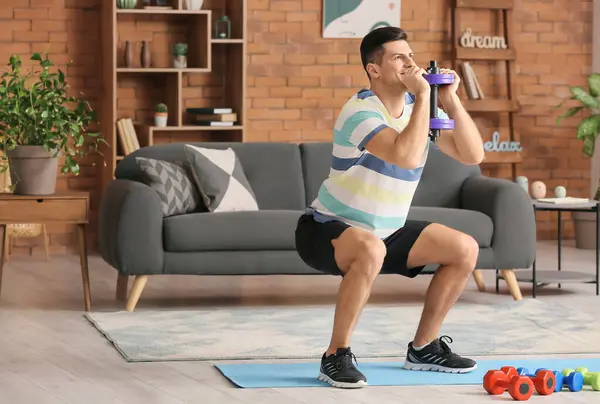 Sporty Young Man Training Dumbbells Home — Stock Photo, Image