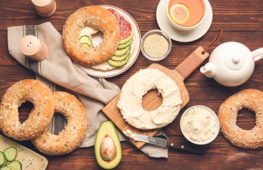 Ahşap arka planda lezzetli krem peynirli simit.