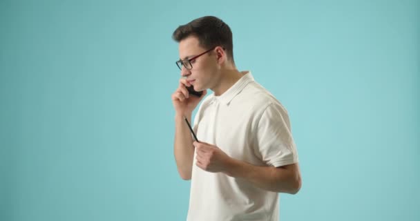 Jeune Homme Parlant Par Téléphone Mobile Sur Fond Couleur — Video