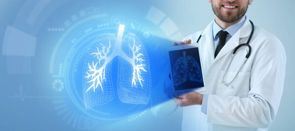 Male doctor holding tablet computer and virtual screen with picture of lungs on color background