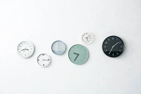 Different Stylish Clocks Hanging Light Wall — Stock Photo, Image