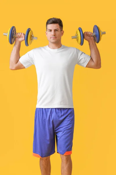 Sporty Young Man Training Dumbbells Color Background — Stock Photo, Image