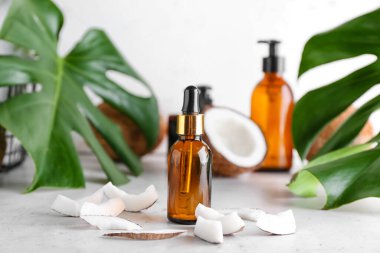 Hafif arka planda hindistan cevizi yağı şişesi ile kompozisyon