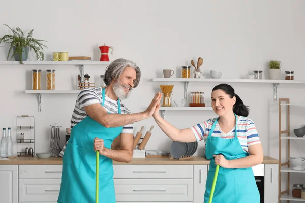 Mature Couple Giving Each Other High Five While Cleaning Kitchen — Stock Photo, Image