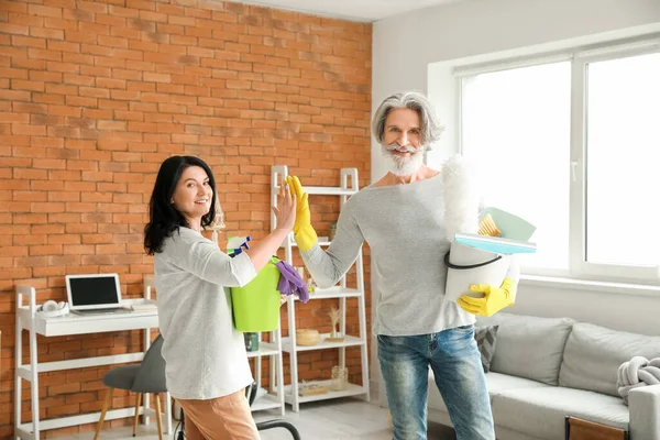 Mature Couple Cleaning Supplies Giving Each Other High Five Home — Stock Photo, Image