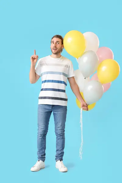 Handsome Young Man Balloons Pointing Something Color Background — Stock Photo, Image