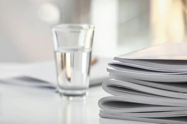 Stack of blank magazines on table