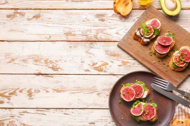 Ahşap arka planda taze bruschetta tabağı ve tabağı.