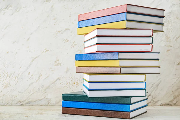 Stack of books on light background