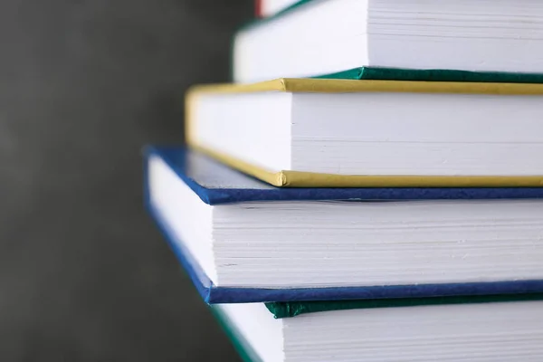 Stack of books on dark background, closeup