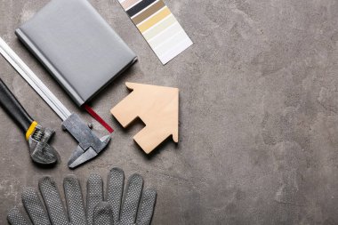 Grunge arkaplanındaki ev ve inşaat araçlarının şekli