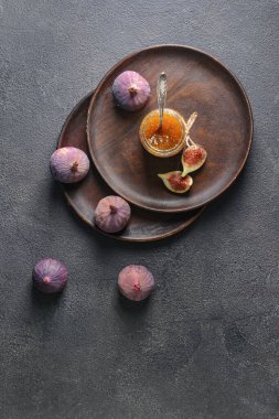 Composition with sweet fig jam on dark background