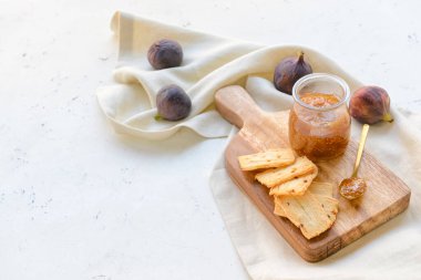Composition with sweet fig jam on light background