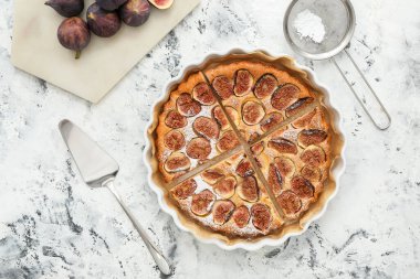 Delicious fig pie on grunge background