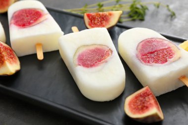 Composition with delicious fig ice-cream on dark background, closeup