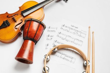 Different musical instruments and music notes on white background