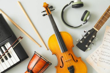 Different musical instruments and music notes on light background