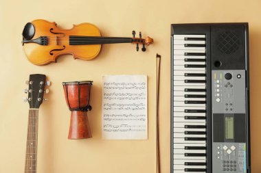 Different musical instruments and music notes on color background