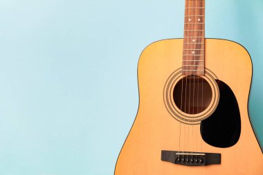 Acoustic guitar on color background, closeup