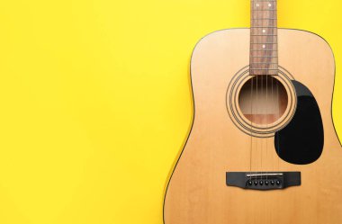 Acoustic guitar on color background