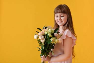 Renkli arka planda bir buket güzel çiçeği olan sevimli küçük bir kız.