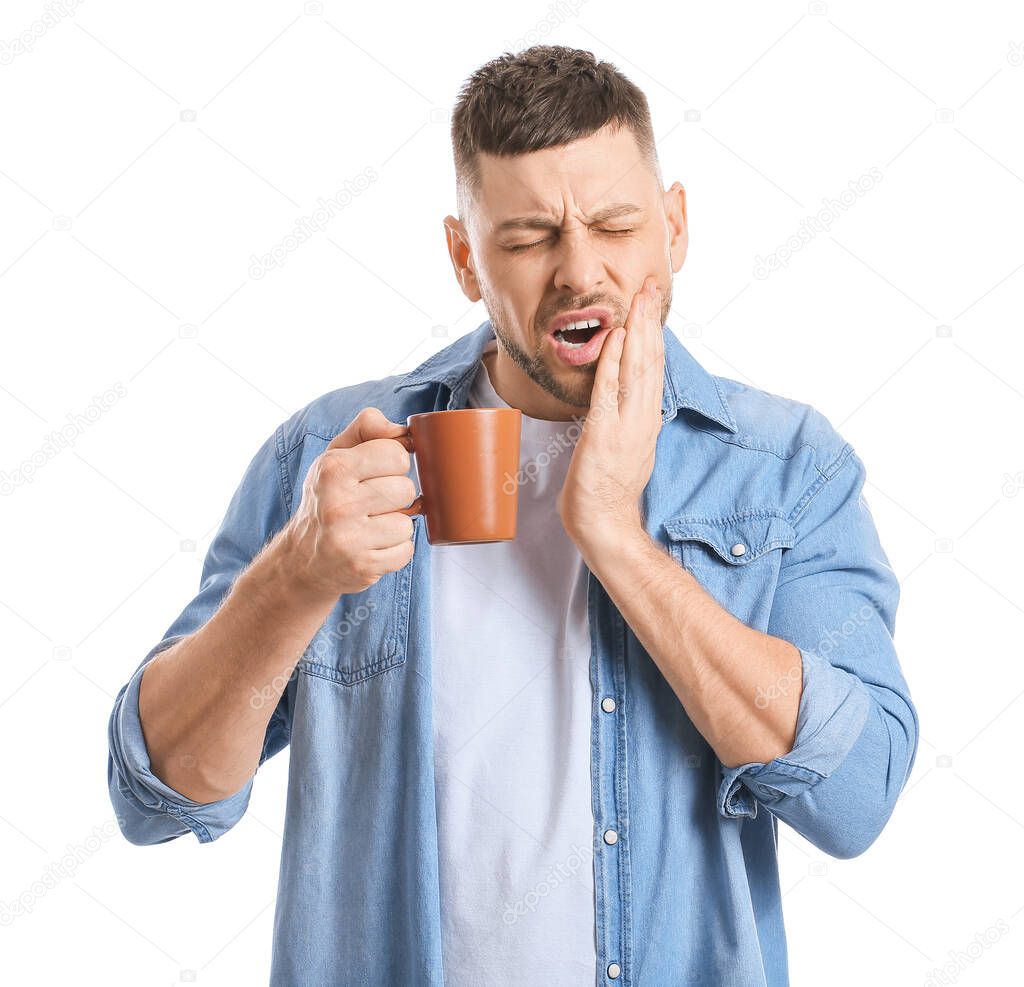Man with sensitive teeth and hot coffee on white background