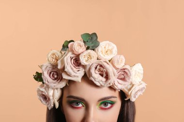 Yaratıcı makyajlı güzel bir genç kadının portresi ve kafasının üzerinde renkler var.