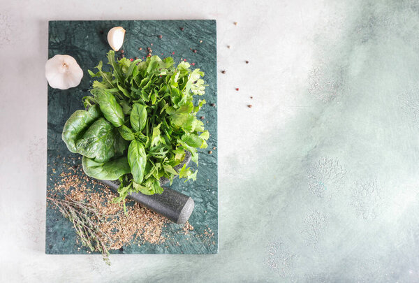 Mortar with herbs on table