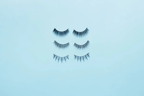 Different false eyelashes on color background