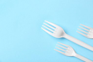 Renk arkaplanındaki plastik çatallar