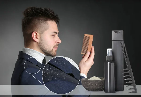 Young man with problem of dandruff and cosmetics for hair treatment on dark background