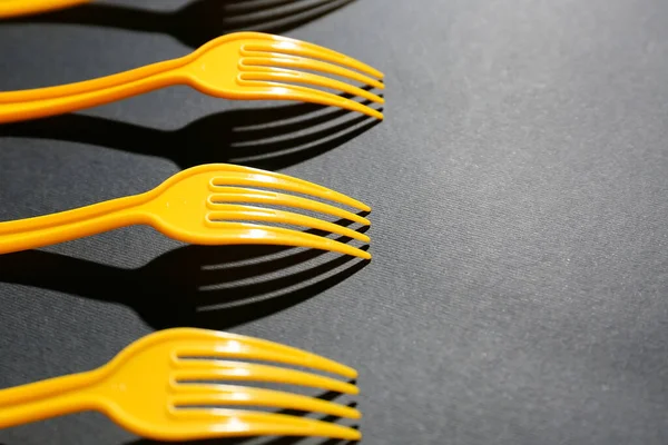 Plastic forks on dark background