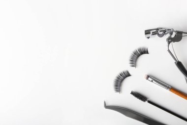 Beyaz arkaplanda takma kirpikler ve araçlar