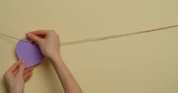 Vrouw Maken Slinger Met Papier Harten Kleur Achtergrond — Stockvideo