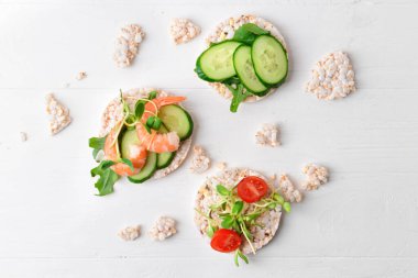 Beyaz ahşap zemin üzerinde pirinç krakerleri olan kompozisyon