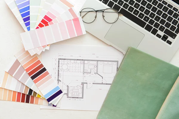 House plan, color palettes and laptop on light background