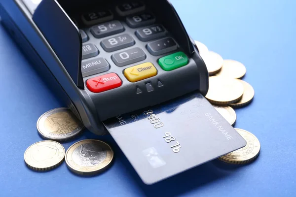 Payment terminal with credit card and money on color background, closeup